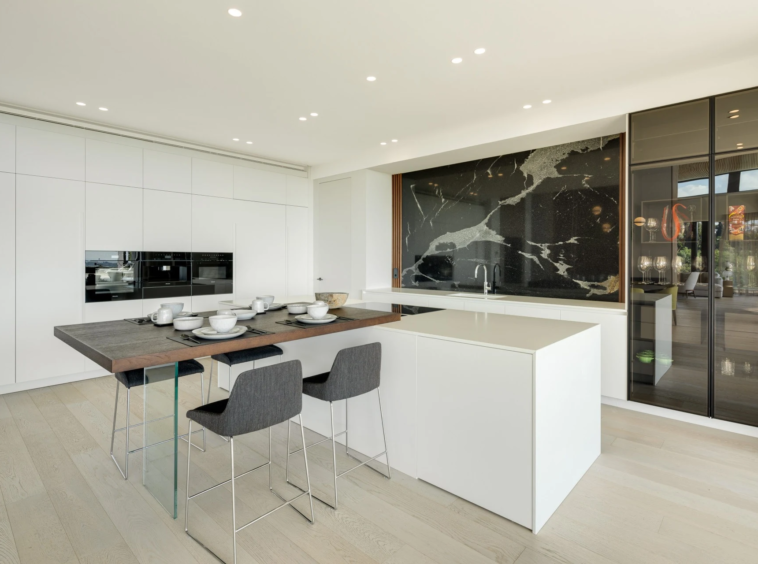 Contemporary kitchen with stone island and integrated appliances