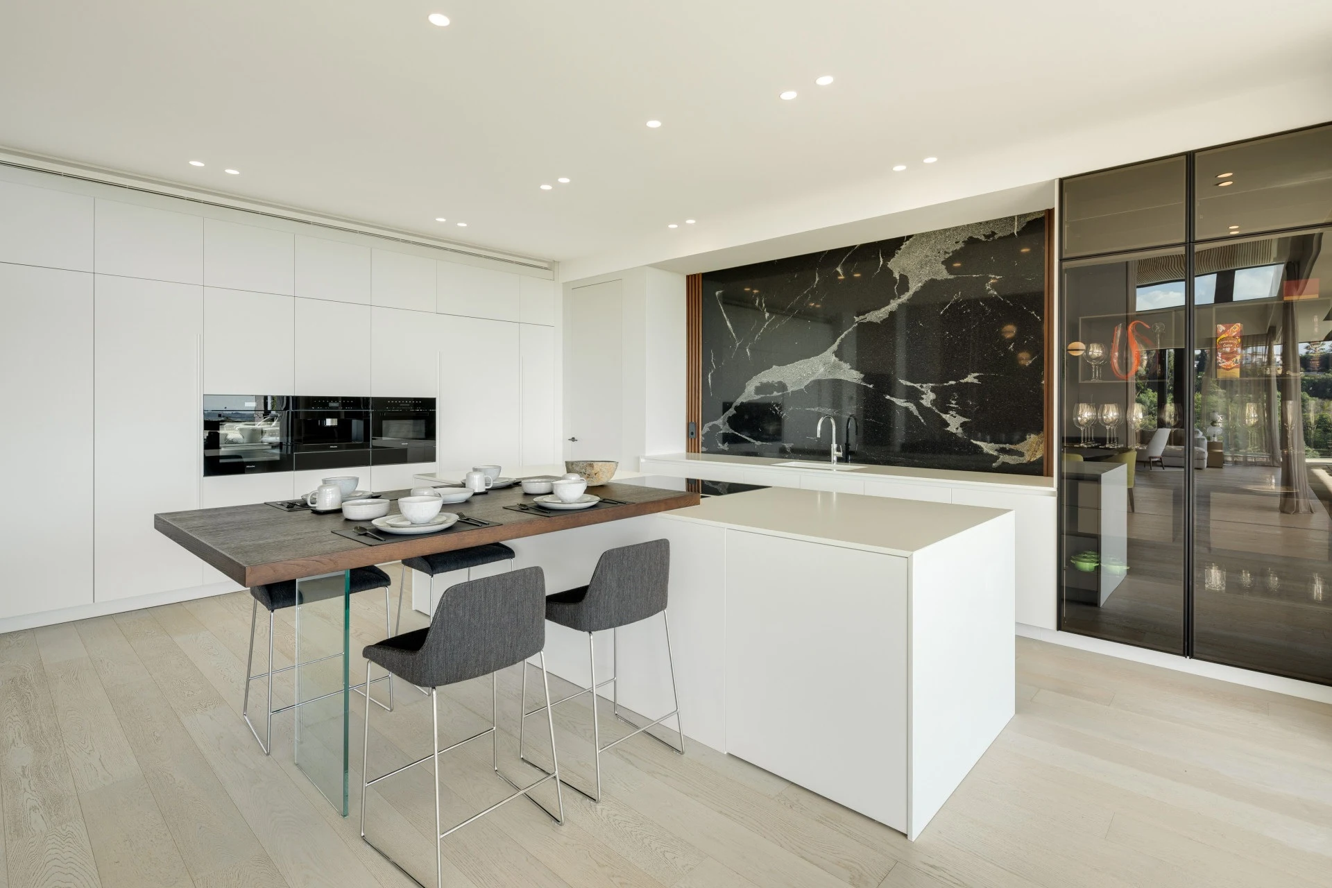 Contemporary kitchen with stone island and integrated appliances