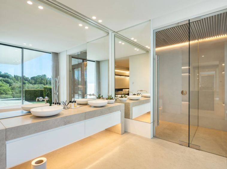 Bathroom with freestanding bathtub and garden-facing windows