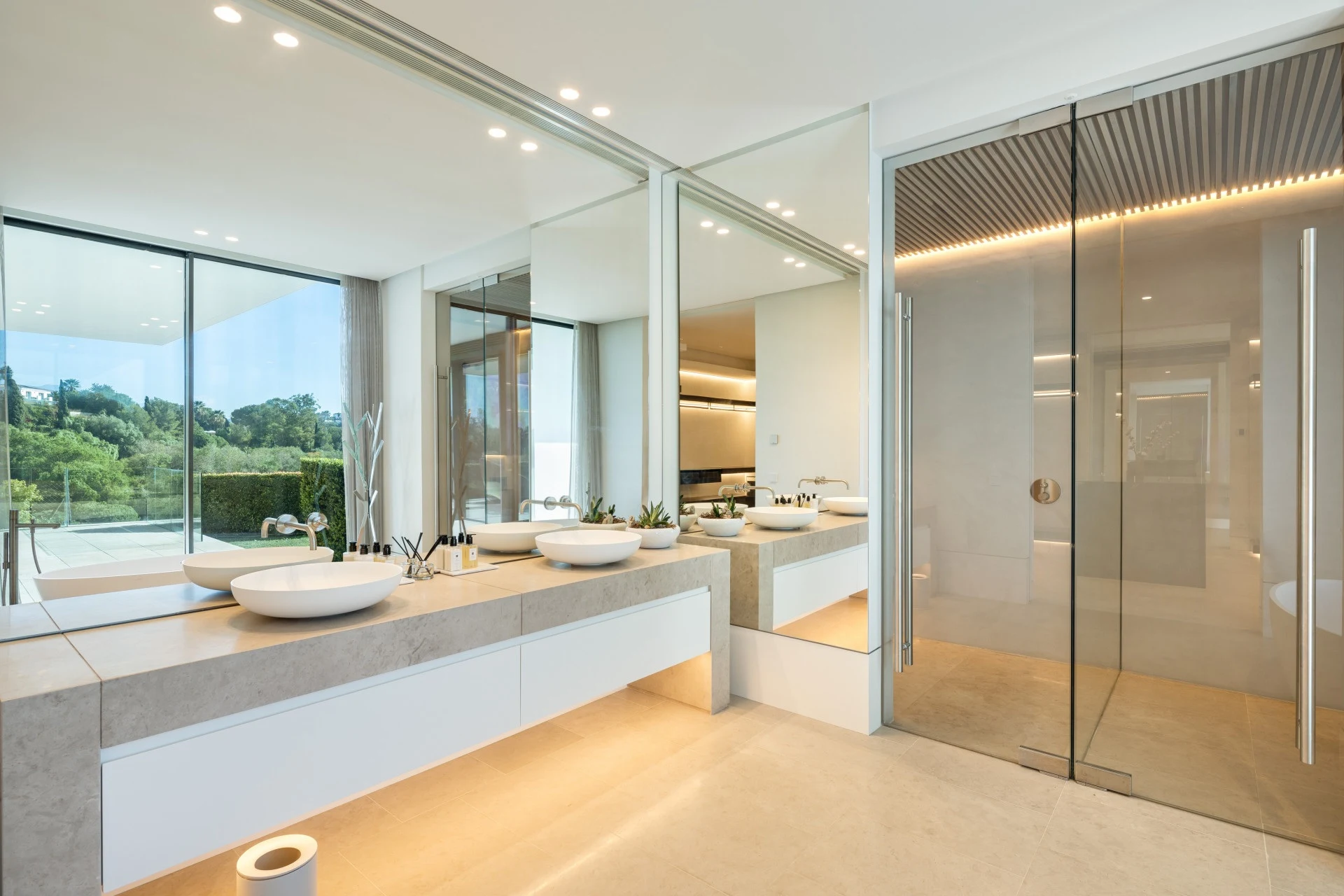Bathroom with freestanding bathtub and garden-facing windows