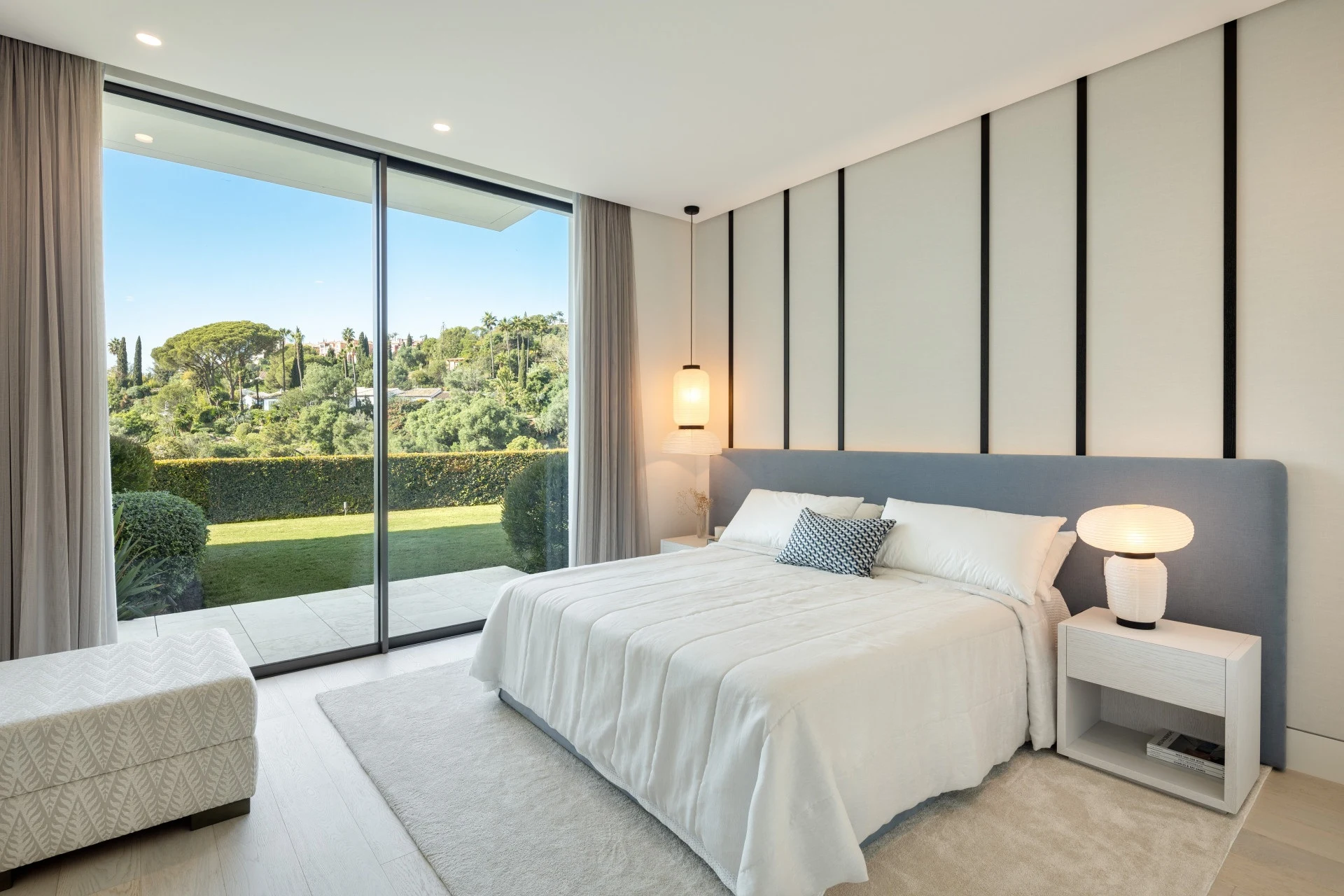 Guest bedroom with landscaped garden views