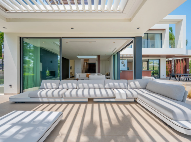 Covered terrace lounge beneath a slatted pergola