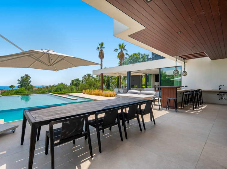 Outdoor dining terrace beside the swimming pool