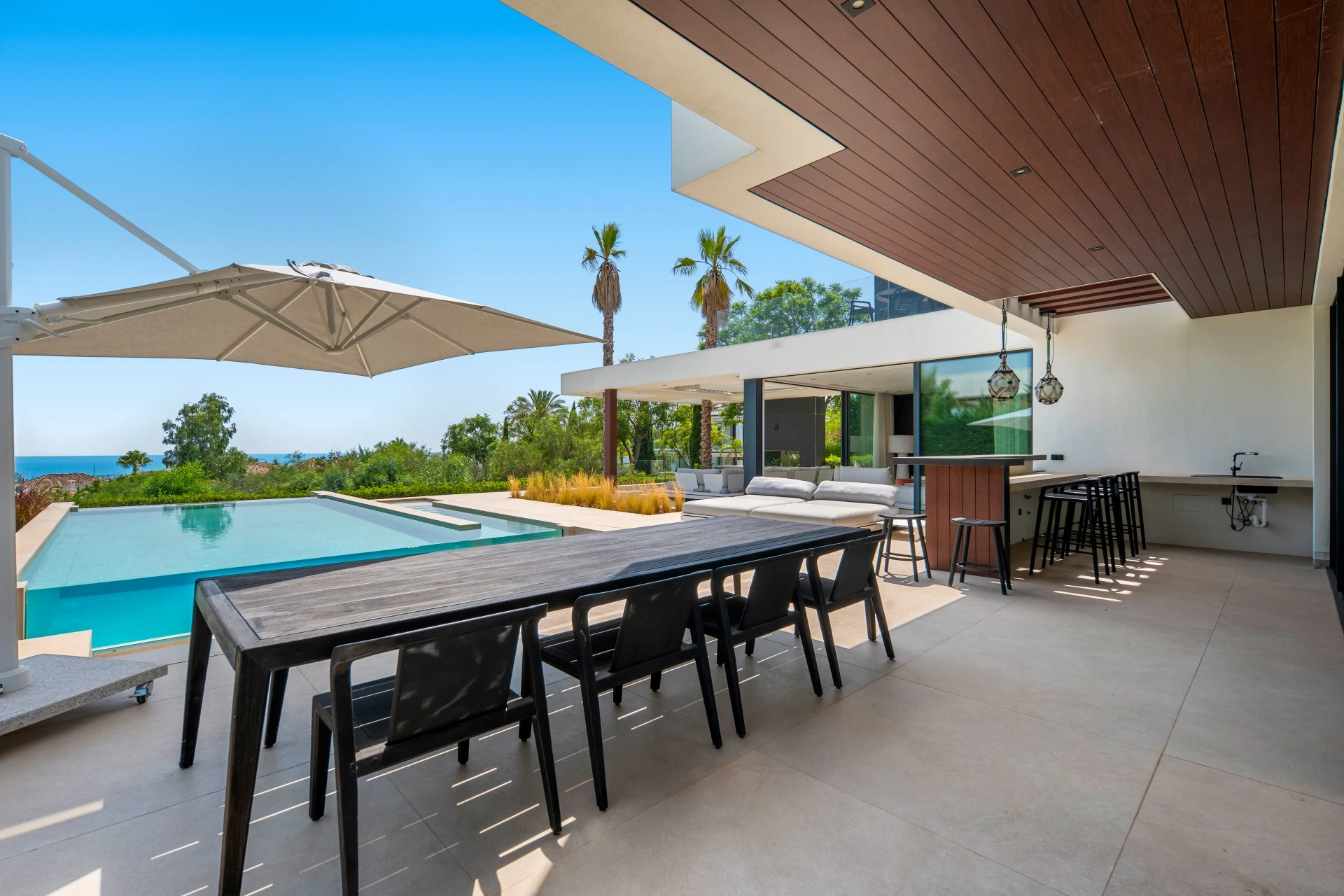 Outdoor dining terrace beside the swimming pool