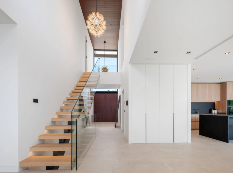 Open staircase beneath a double-height entrance hall