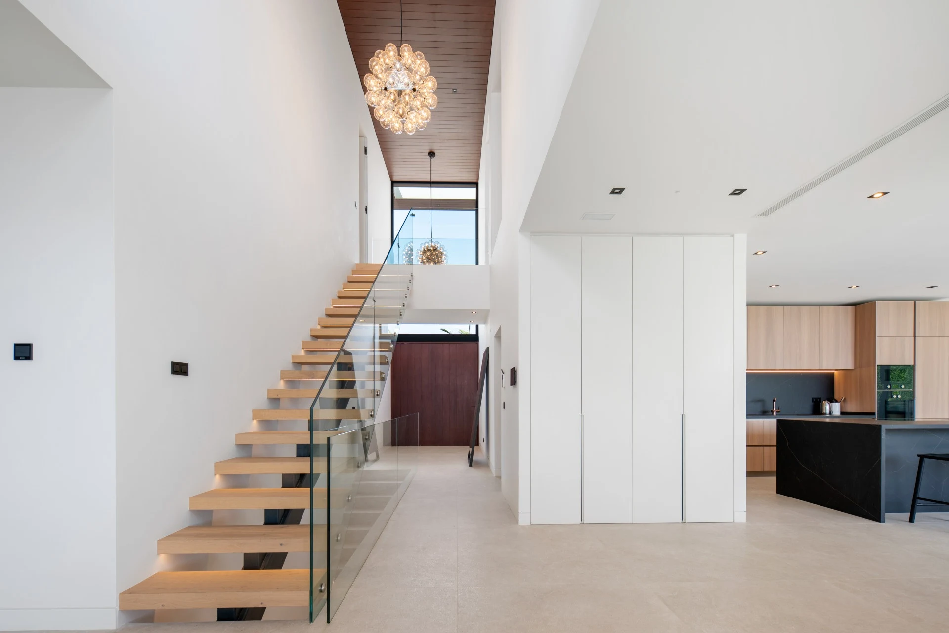 Open staircase beneath a double-height entrance hall