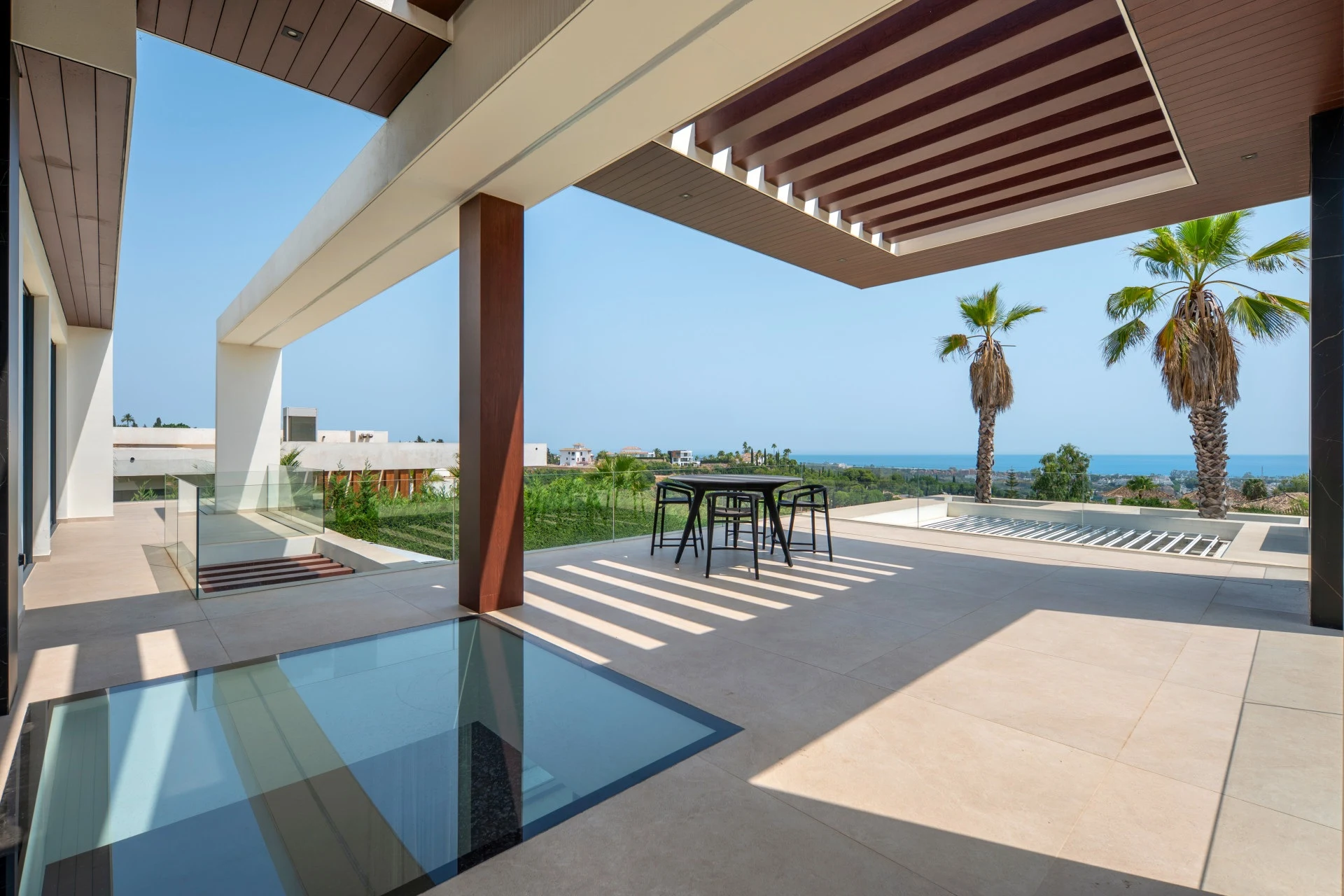 Upper terrace with pergola and views towards the coast