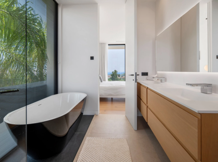 Bathroom with freestanding bath and fitted vanity