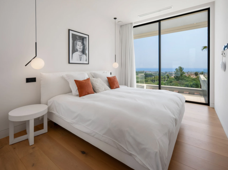 Guest bedroom with orange cushions and terrace access
