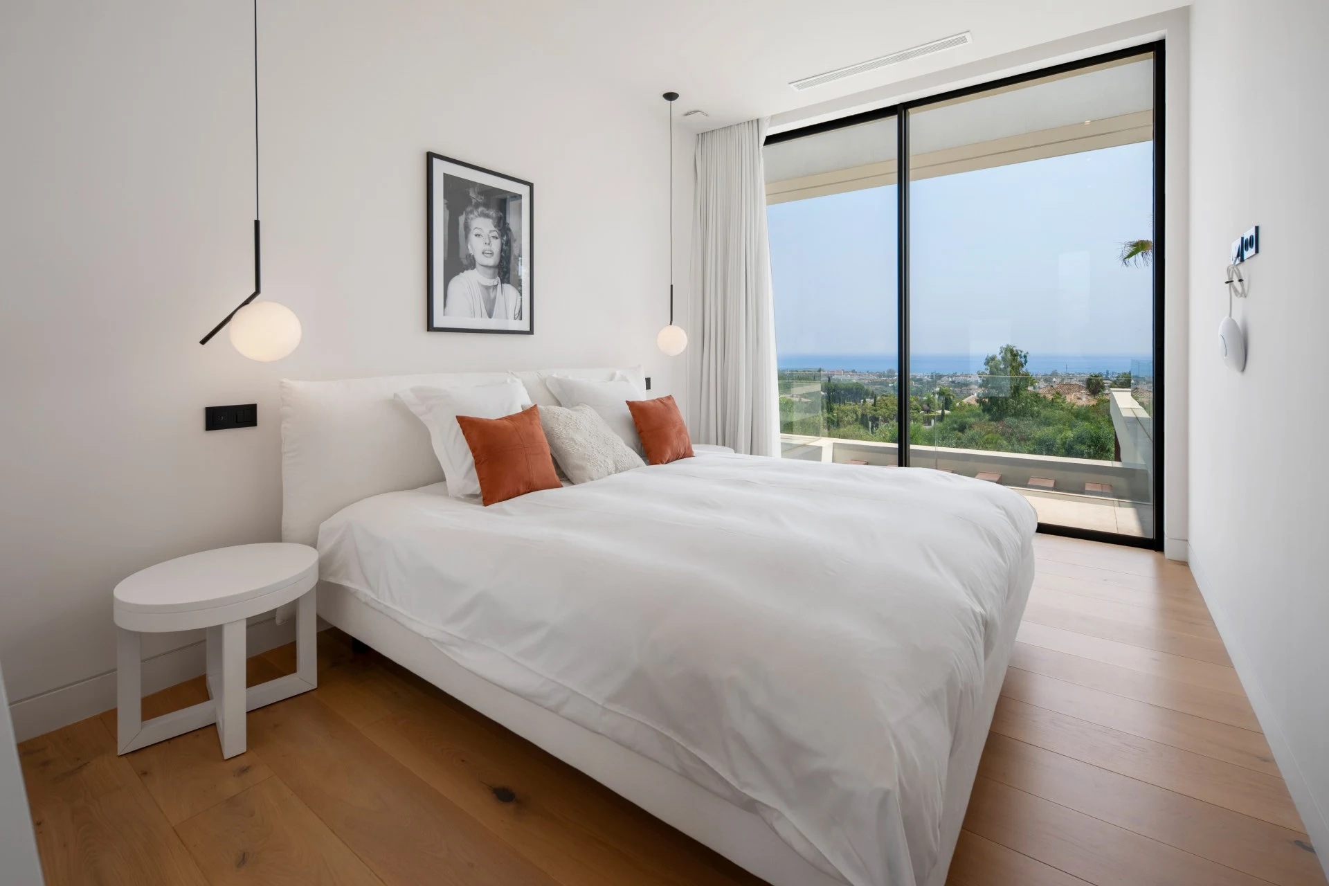 Guest bedroom with orange cushions and terrace access