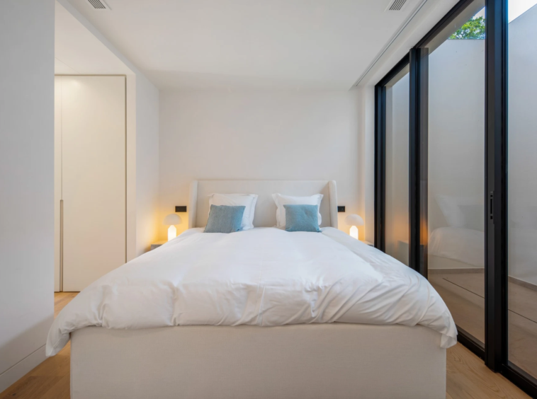 Guest bedroom with glazed courtyard-facing doors