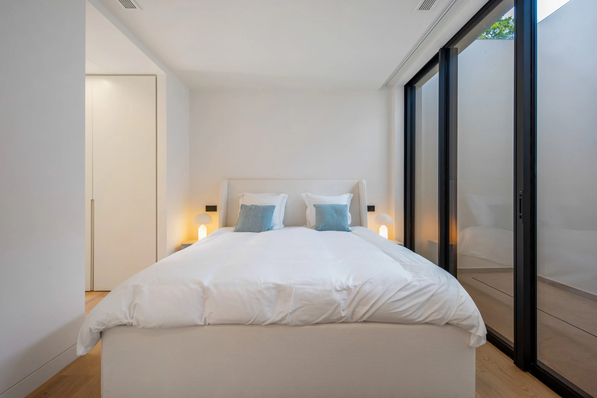 Guest bedroom with glazed courtyard-facing doors