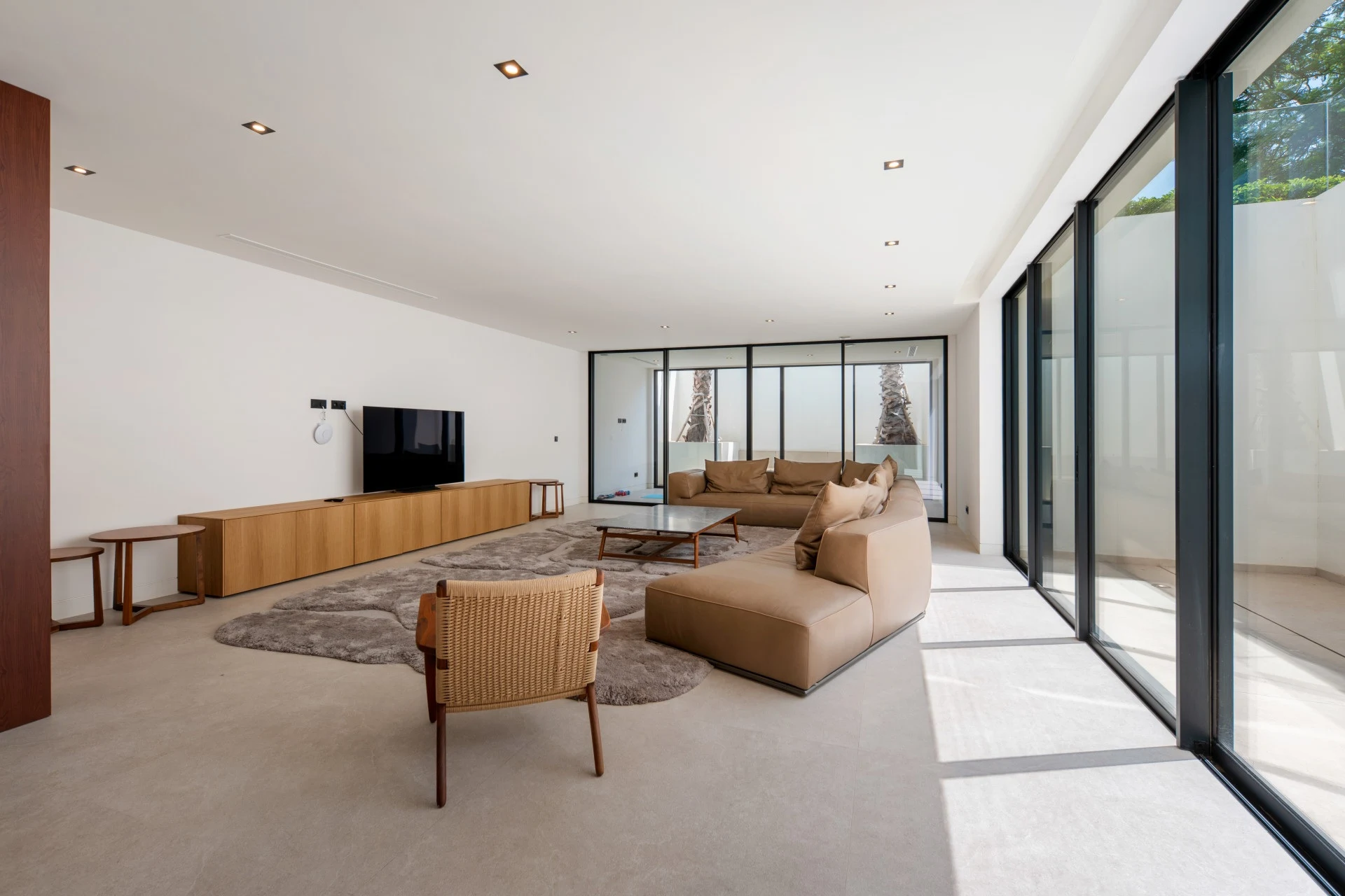 Additional lounge with large windows and timber furnishings