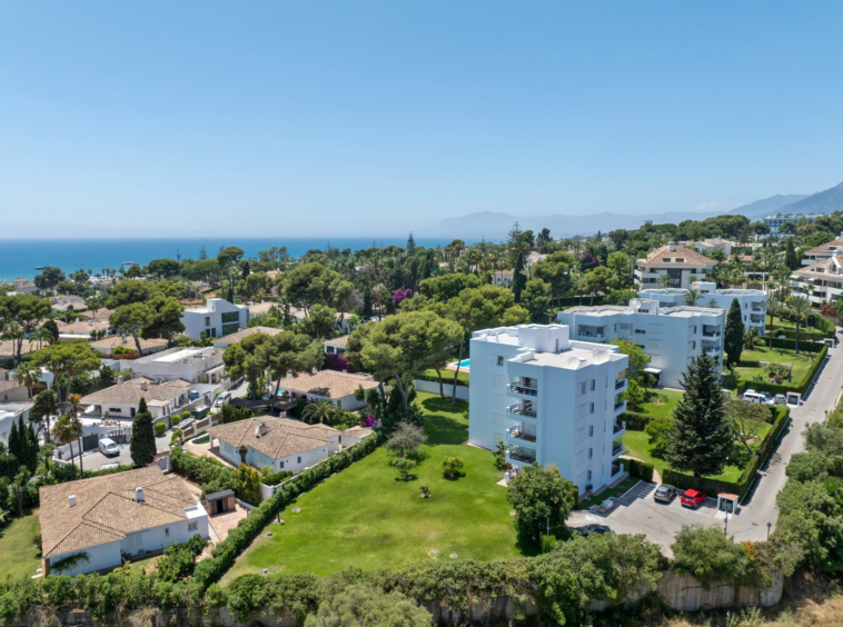 Aerial view of the residential building and coastal surroundings