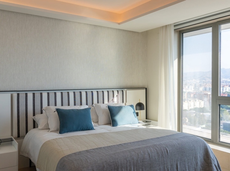 Representative penthouse bedroom with city views