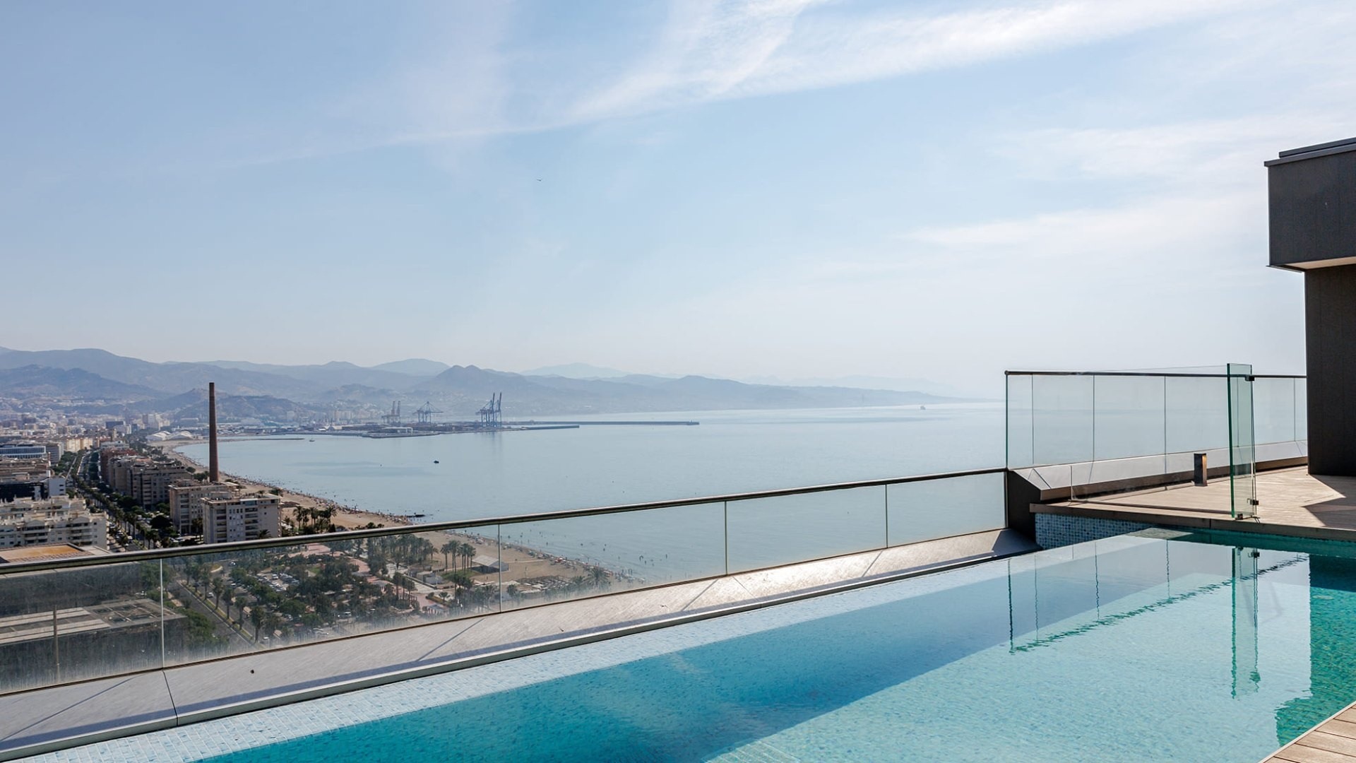 Representative rooftop swimming pool with views across Malaga bay
