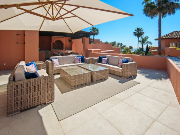 Private terrace lounge with outdoor seating and coastal outlook