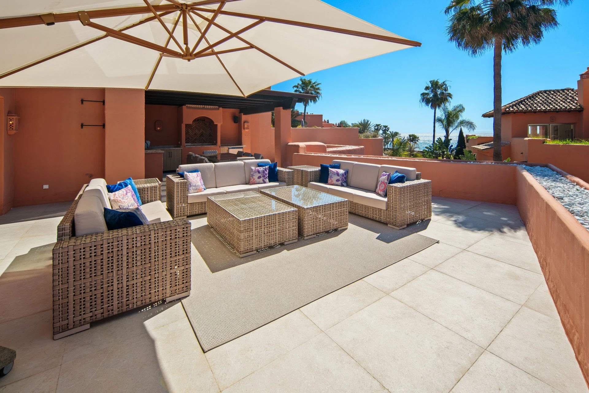 Private terrace lounge with outdoor seating and coastal outlook