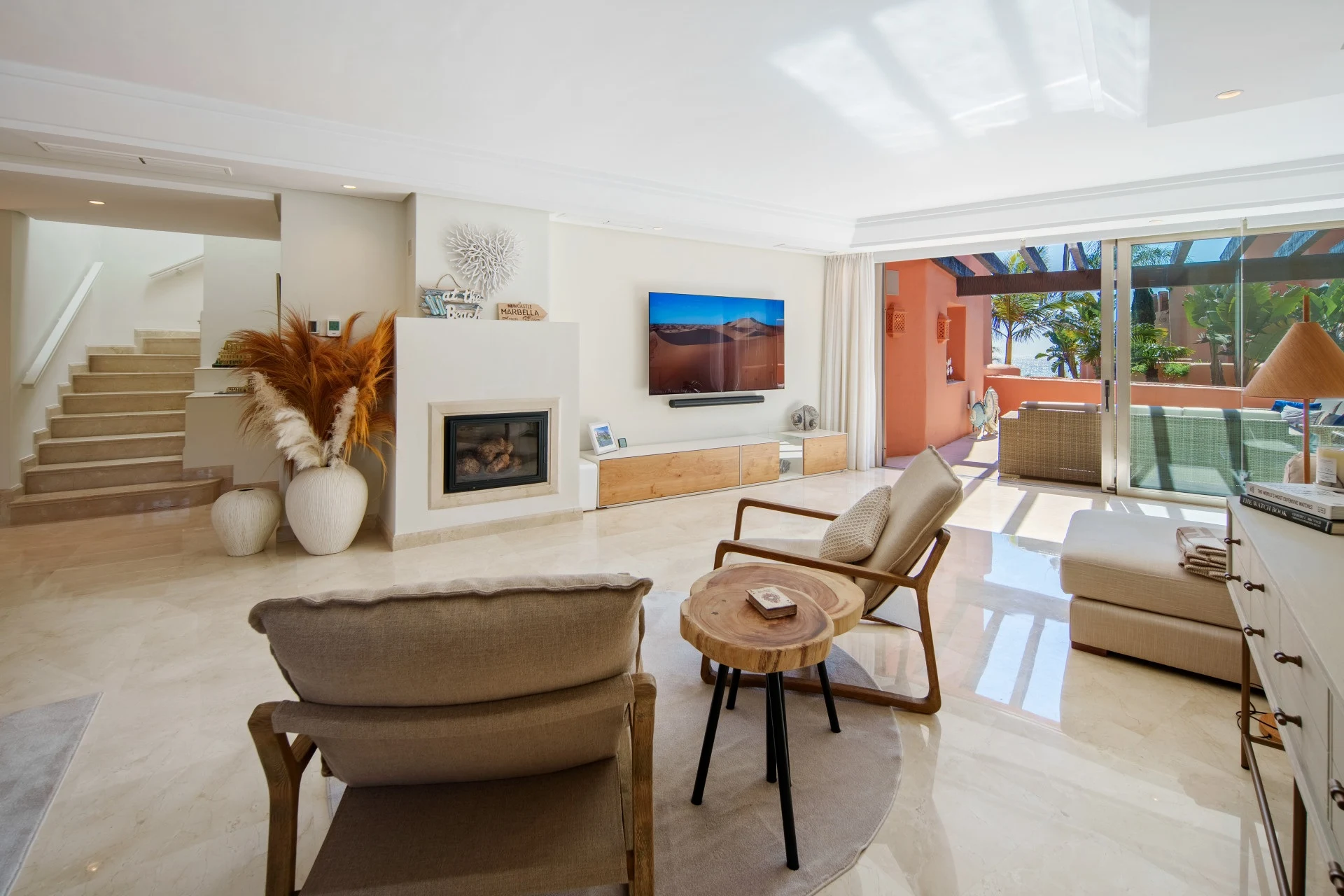 Living area with fireplace and staircase to the upper floor