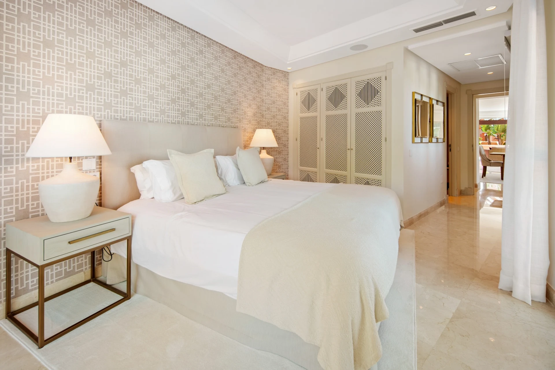 Guest bedroom with fitted wardrobes and soft neutral finishes