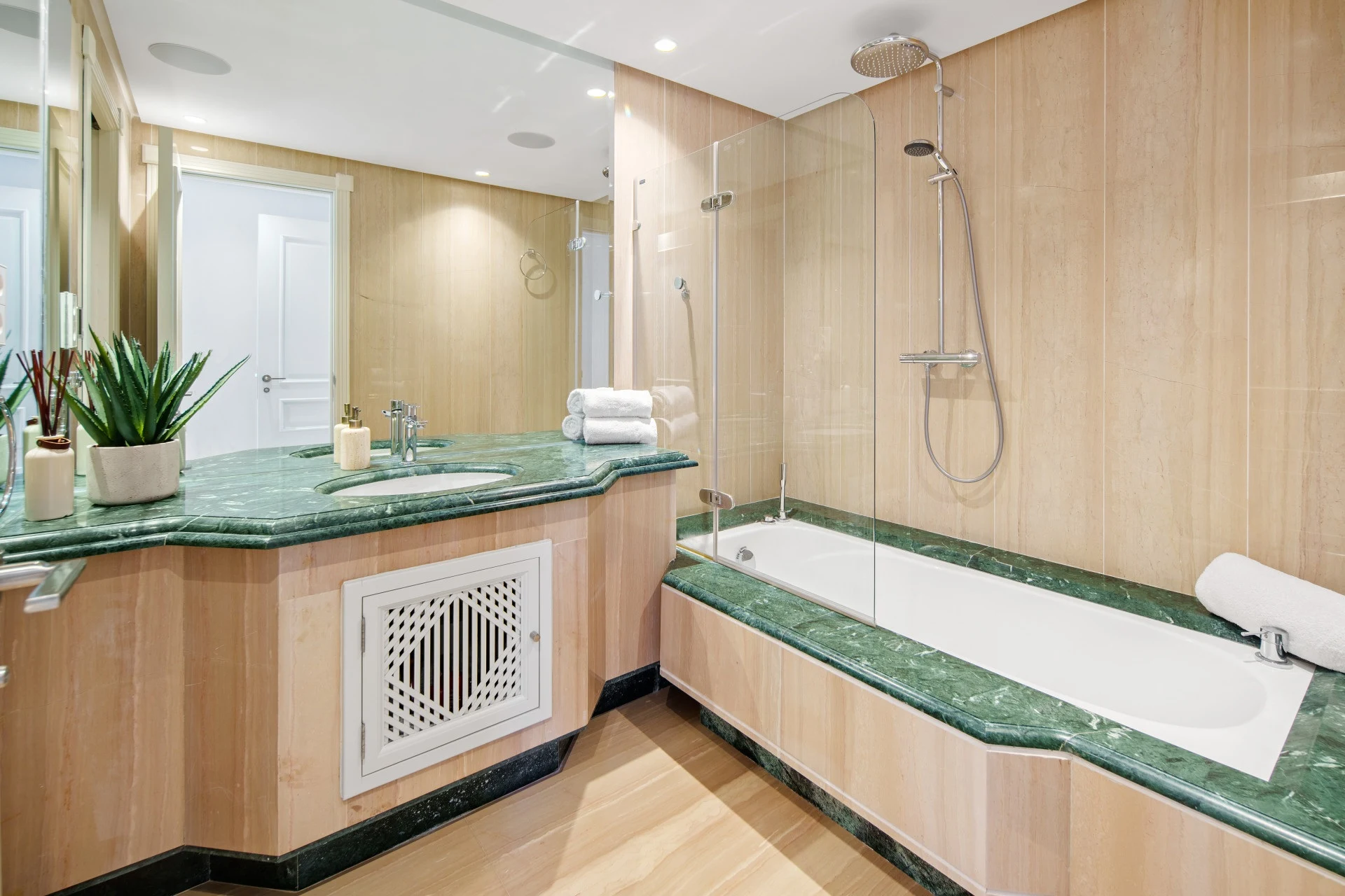 Bathroom with green stone vanity and bathtub