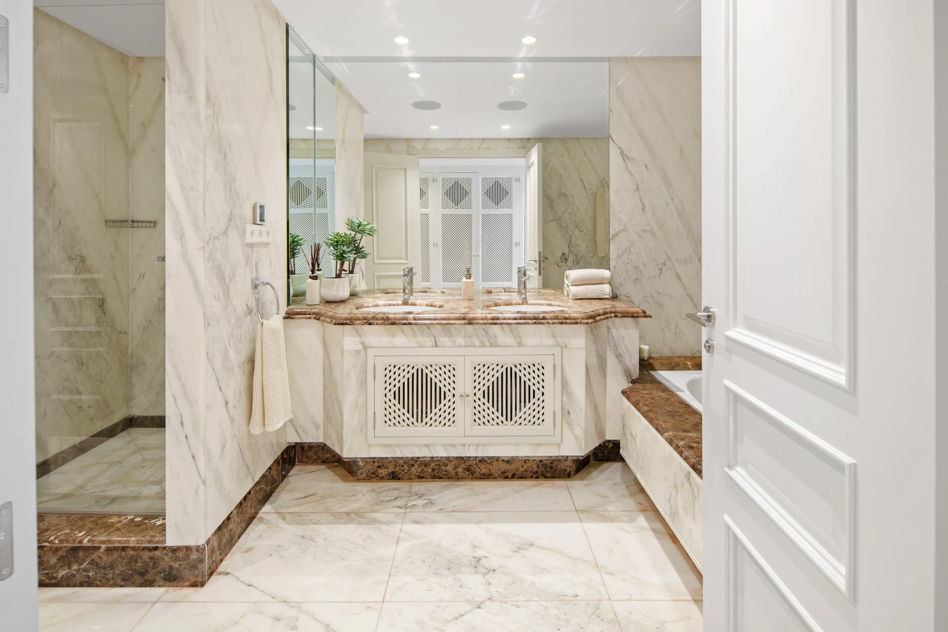 Marble bathroom with fitted vanity and walk-in shower