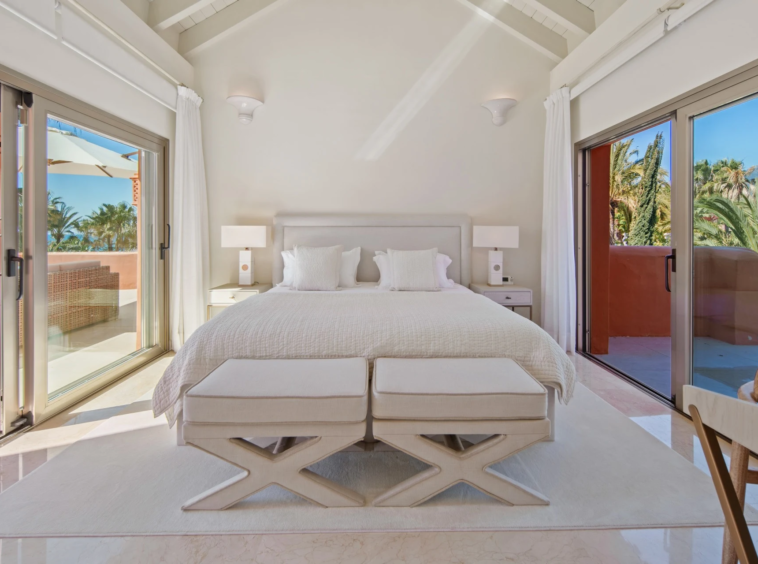 Upper-level bedroom suite opening onto private terraces