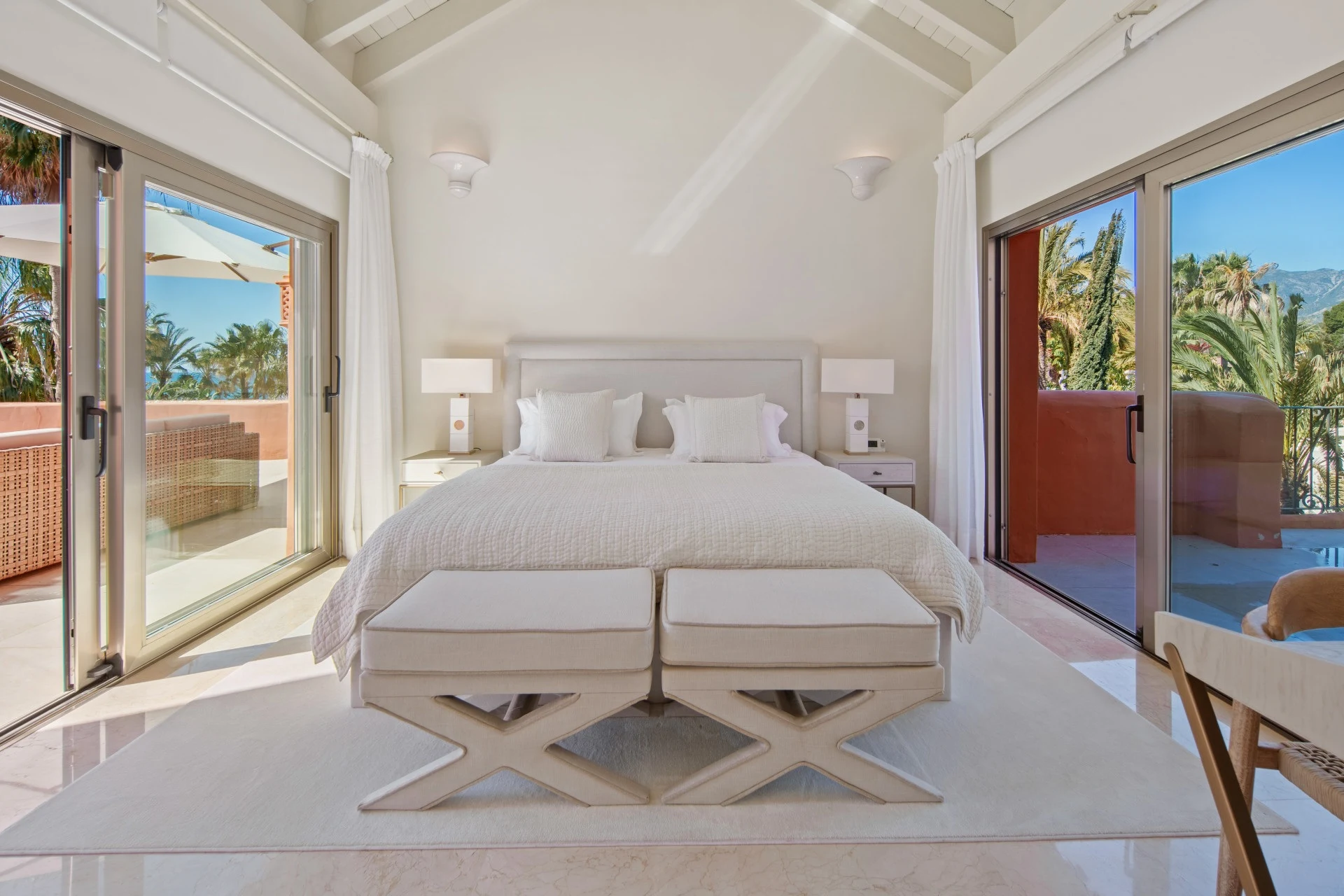 Upper-level bedroom suite opening onto private terraces