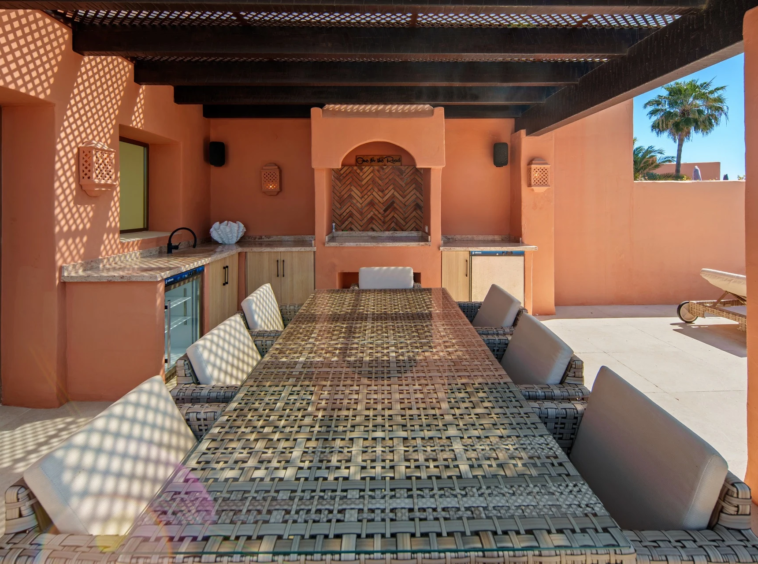 Sheltered terrace dining area with outdoor worktop