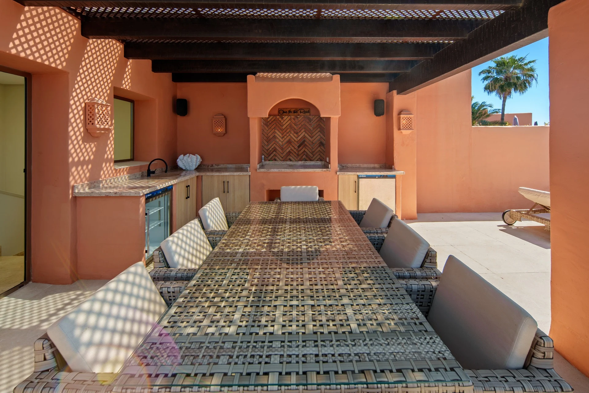 Sheltered terrace dining area with outdoor worktop