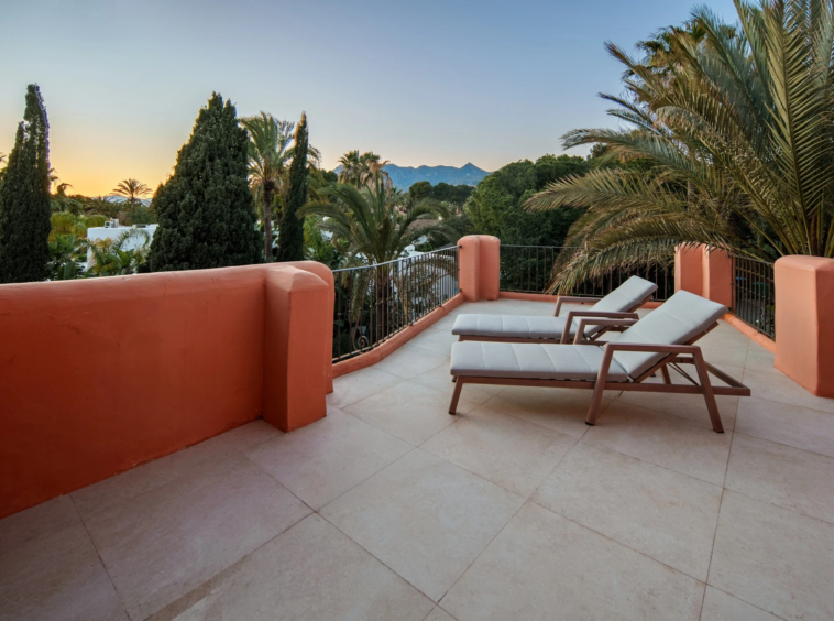 Private terrace with sun loungers overlooking the gardens