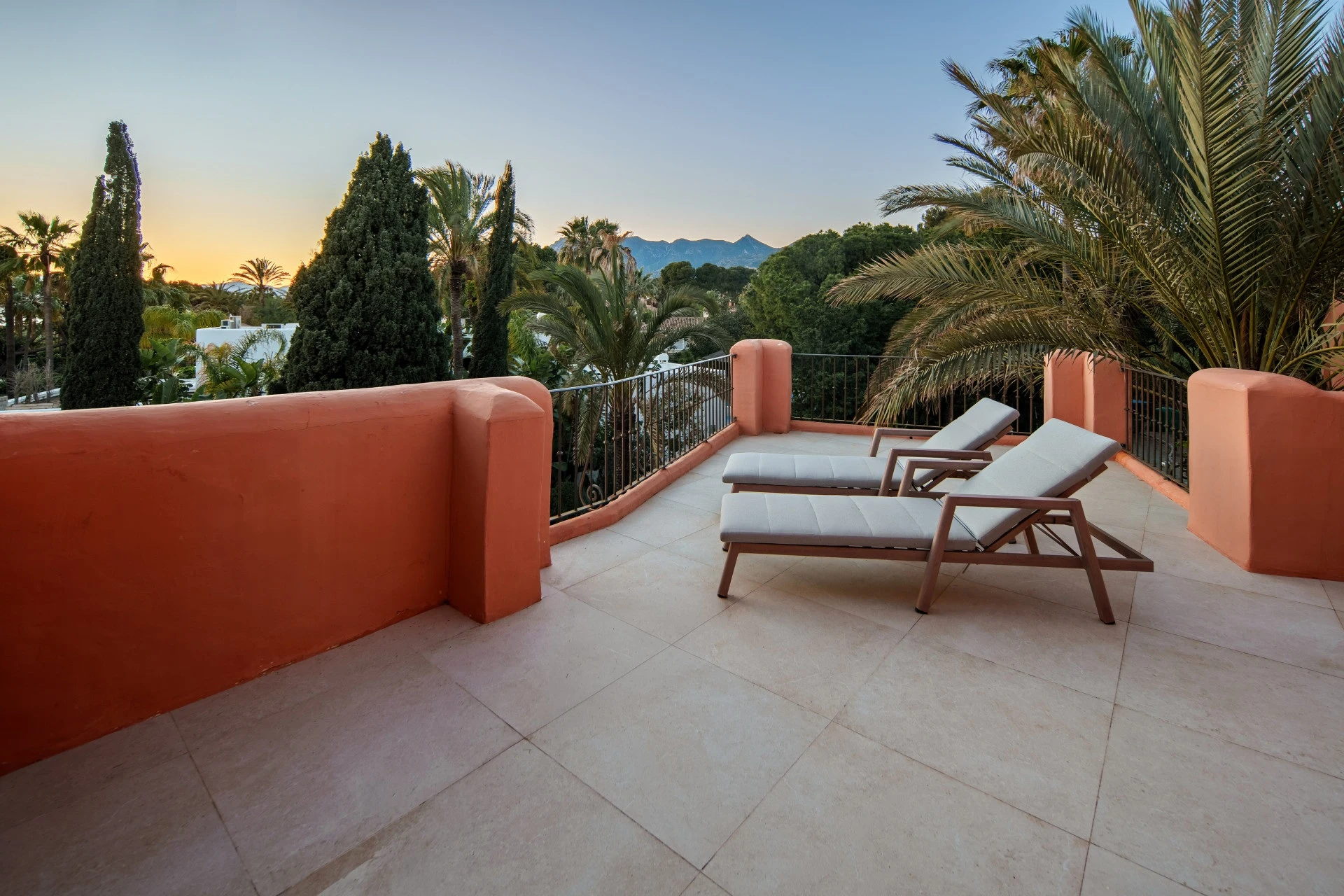 Private terrace with sun loungers overlooking the gardens