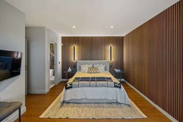 Bedroom with wood-panelled feature wall in Marbella East