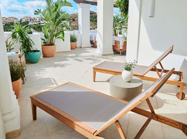 Sunny terrace with lounge chairs