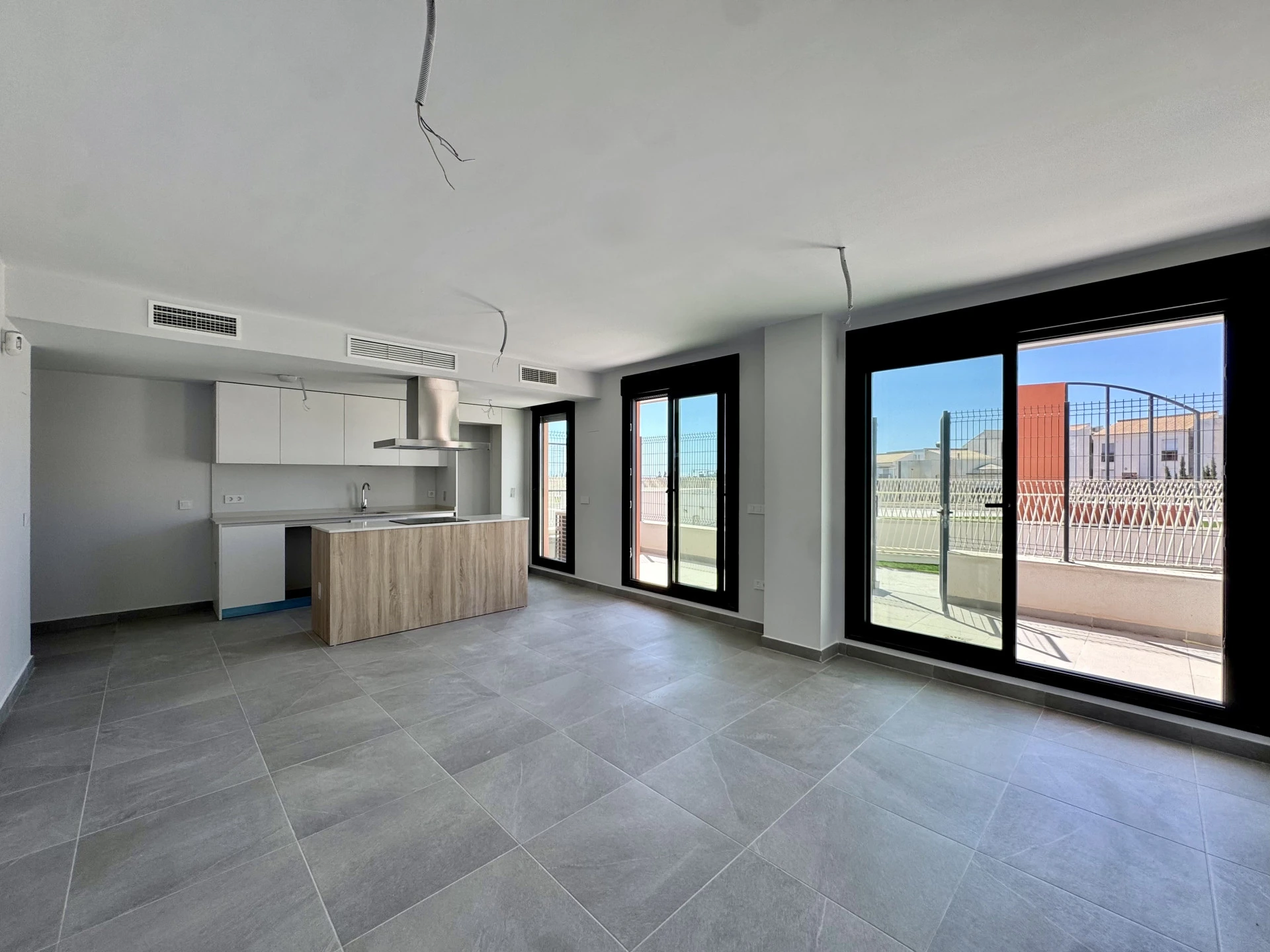 Unfurnished open-plan living area with terrace doors