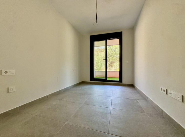 Unfurnished bedroom with glazed door