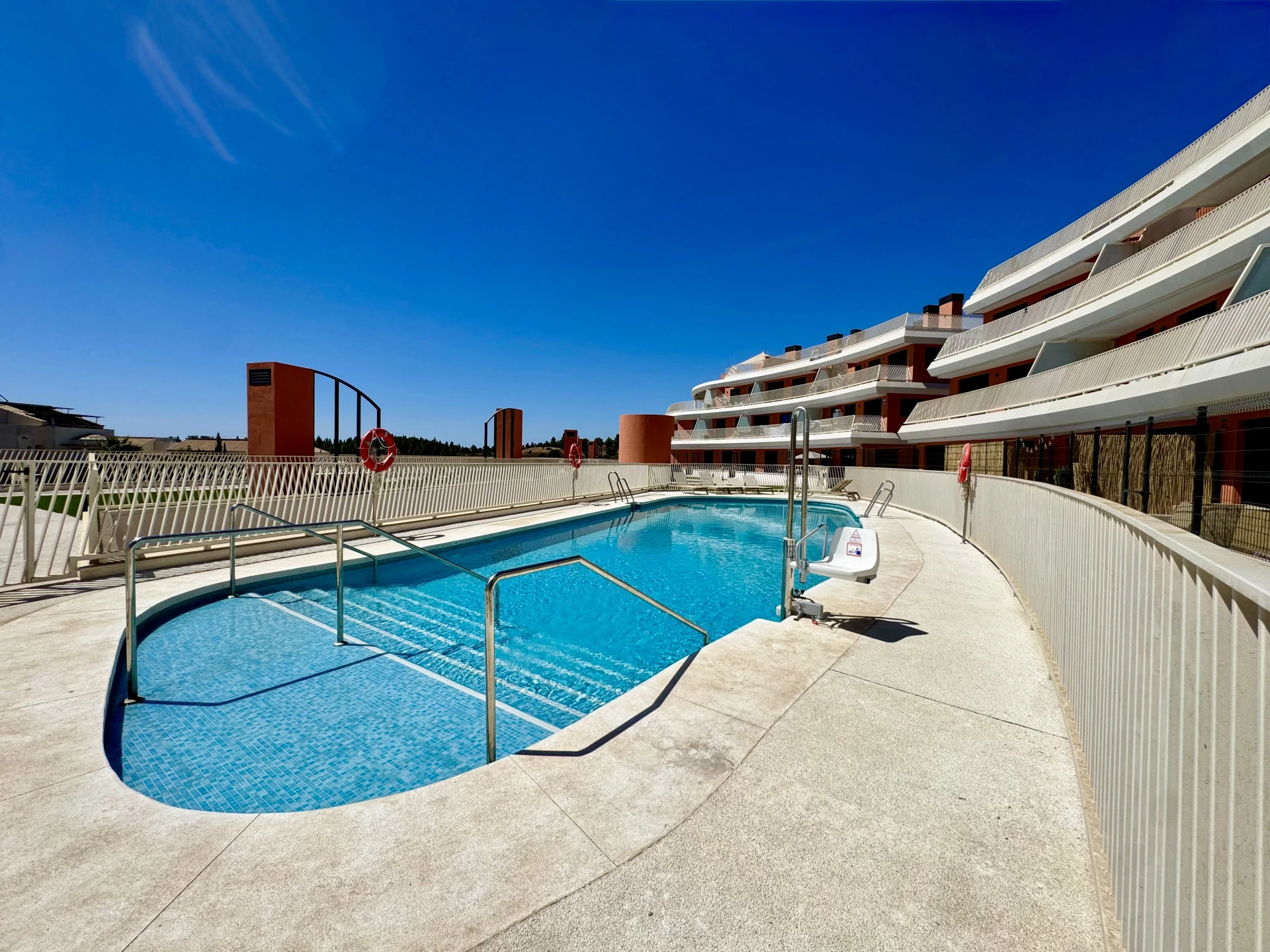 Communal pool and landscaped residential setting