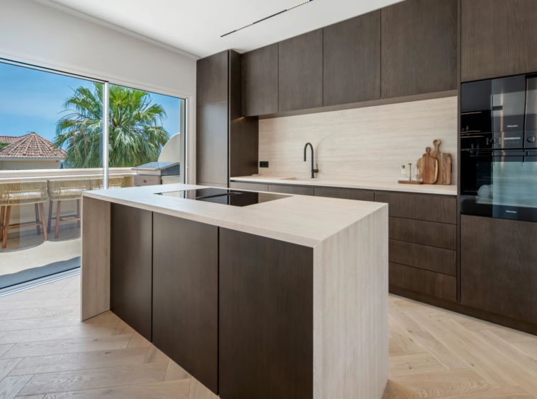 Fitted kitchen with island and dark cabinetry