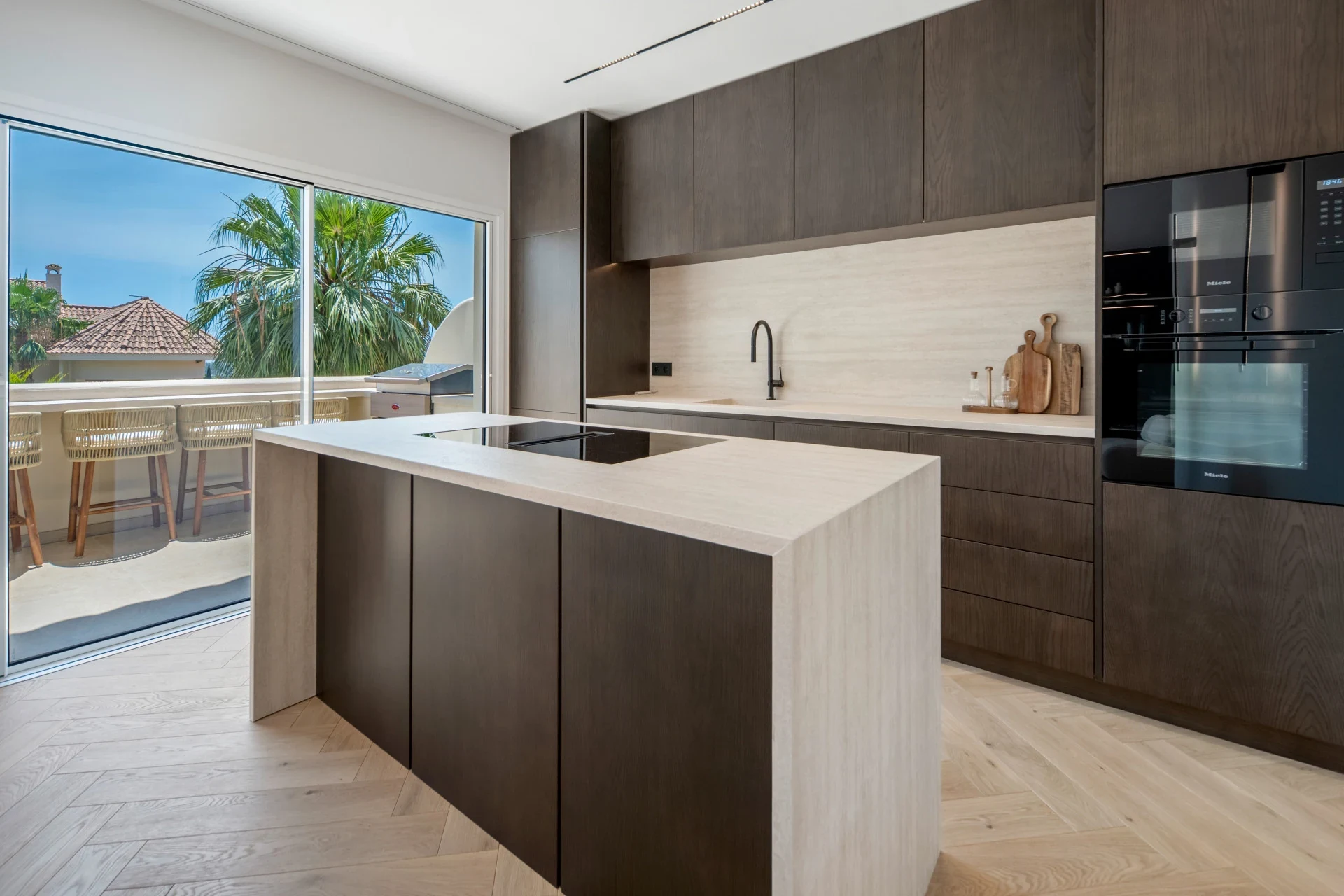 Fitted kitchen with island and dark cabinetry