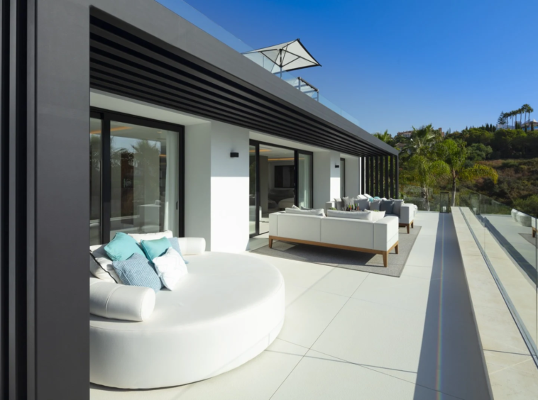 Upper terrace with outdoor seating and glass balustrade