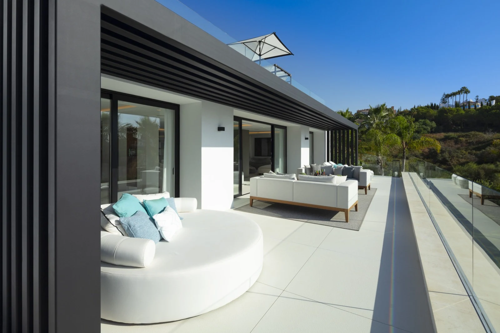Upper terrace with outdoor seating and glass balustrade