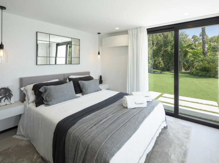 Guest bedroom with access to landscaped outdoor space