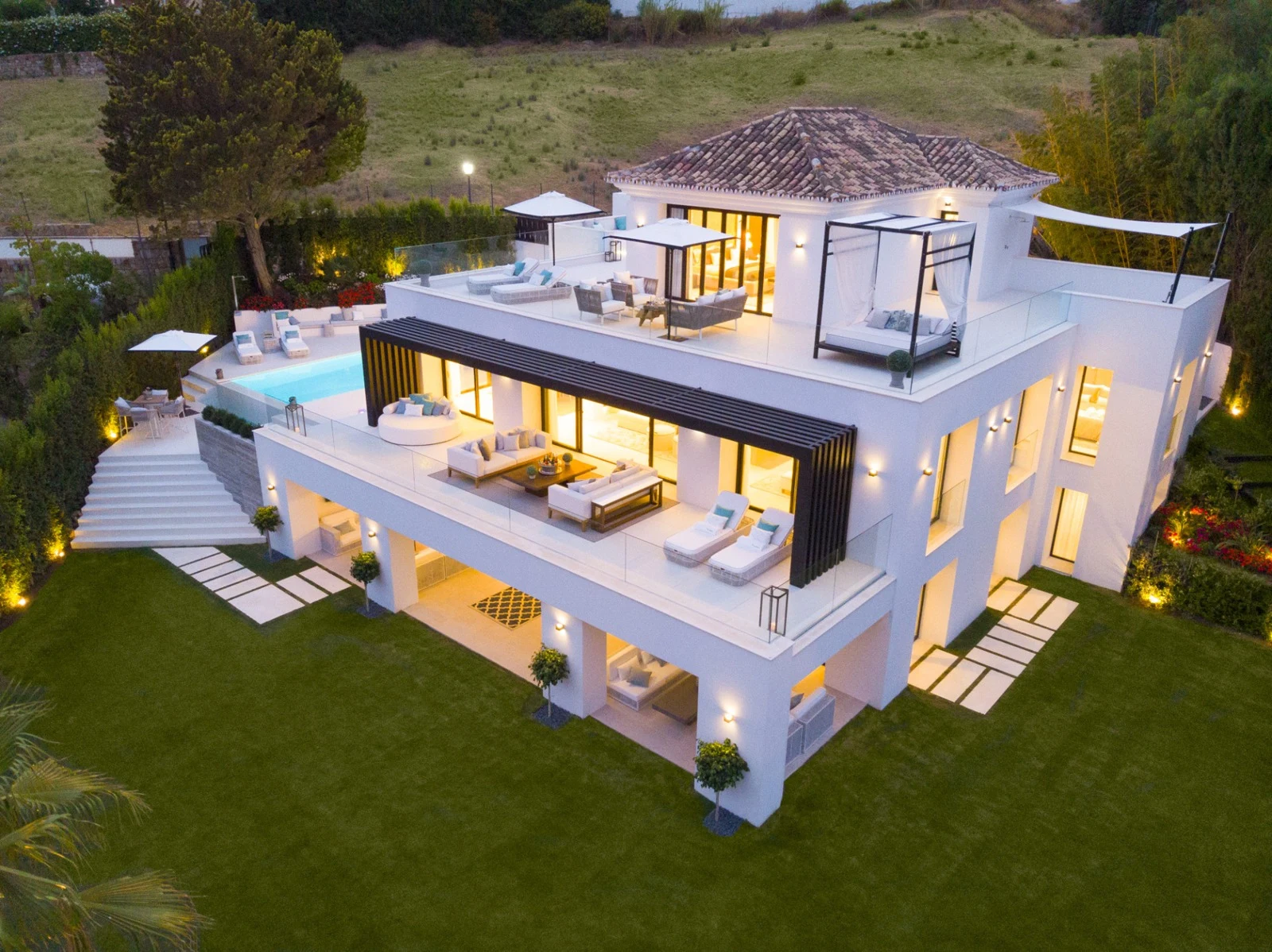Villa and terraces illuminated in the evening