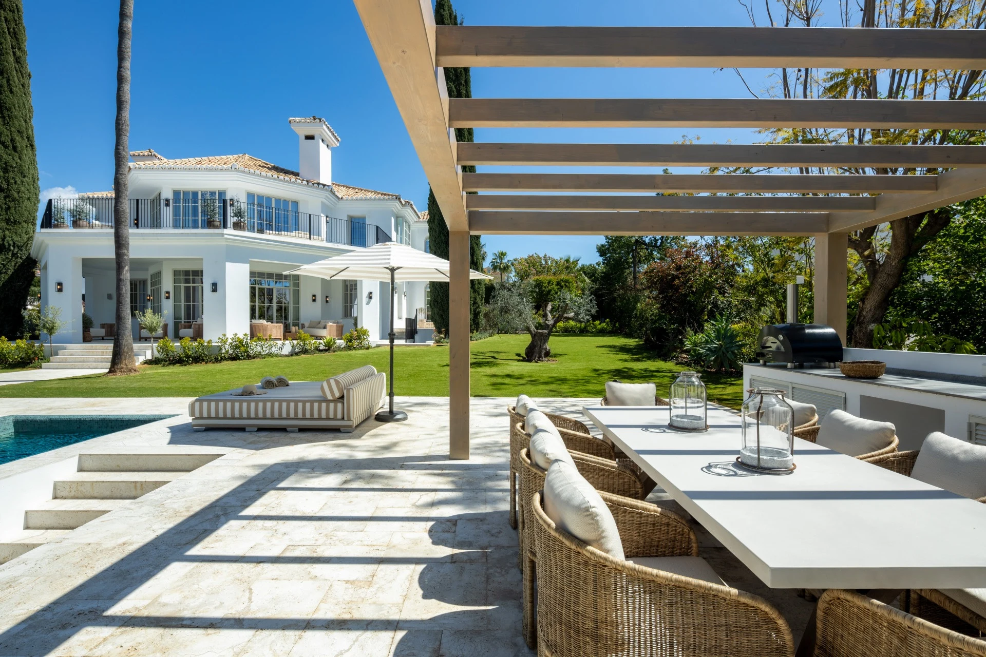 Shaded outdoor dining terrace beside the private swimming pool