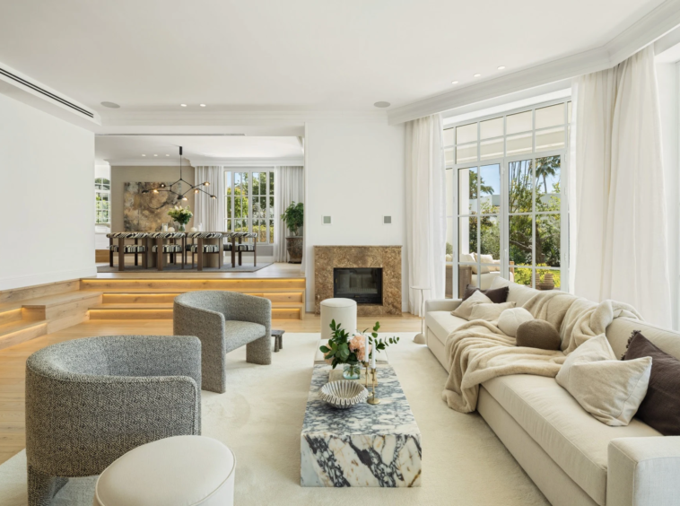 Bright living room with fireplace and garden-facing windows