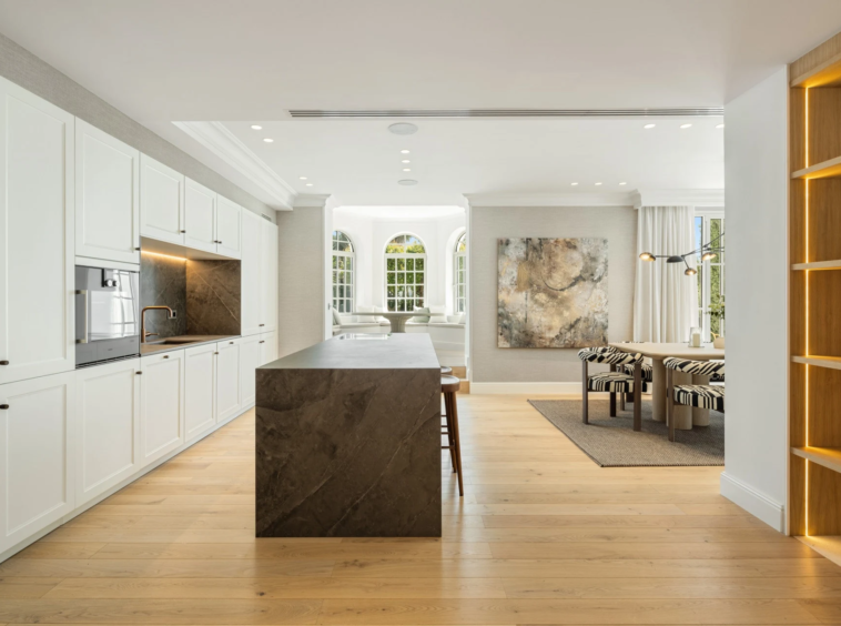 Modern kitchen with a dark stone island and integrated appliances