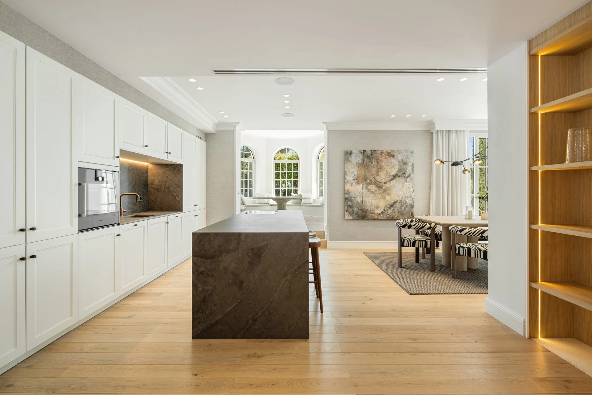 Modern kitchen with a dark stone island and integrated appliances