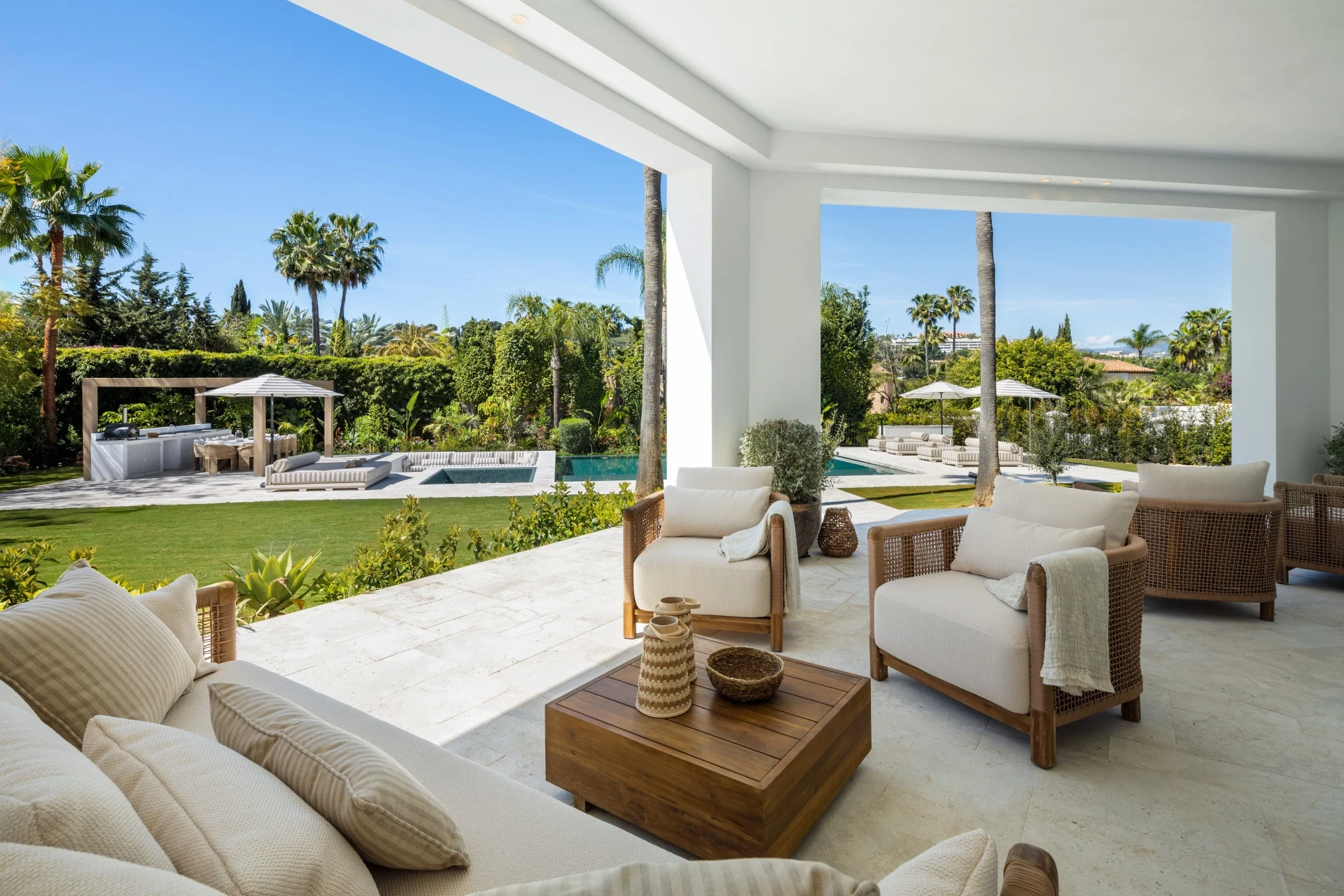 Covered terrace overlooking the private garden and pool