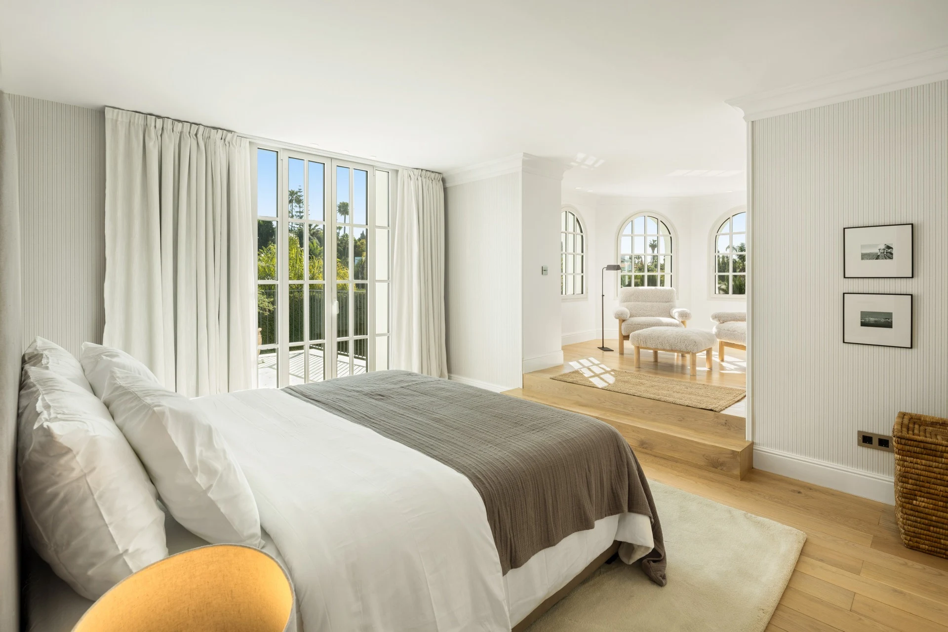Guest bedroom with garden-facing windows and seating area