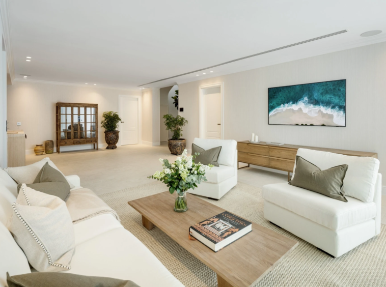 Lower-level lounge with pale sofas and contemporary artwork